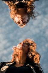 women photographed against blue sky