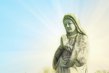 Virgin Mary statue. Vintage sculpture of sad woman in grief (Religion, faith, suffering, love concept) Retro filter.