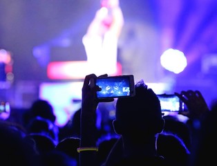 fans who take photos and record videos with smartphones during t