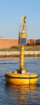 industrial yellow buoy for signaling to ships with a small photo