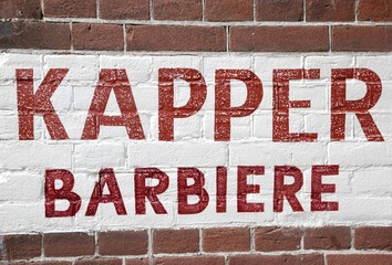 Obraz premium wall with barber shop sign written in Dutch and Italian