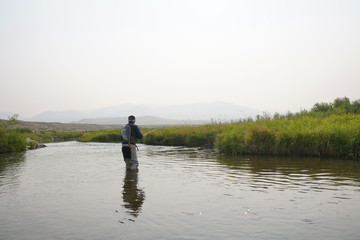 Fly fisherman fishing in river of Montana state