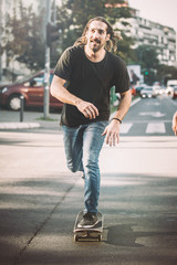 Pro skateboard rider in front of car on city road © guruXOX