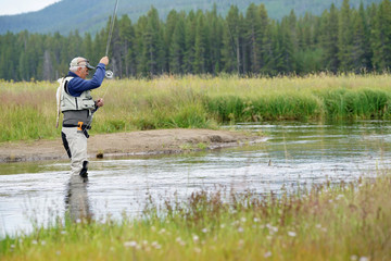 Fototapeta na wymiar Fly-fisherman fishing in the Gallatin River, Montana