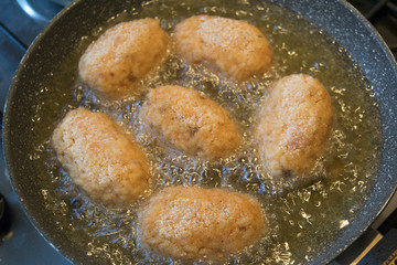 rice croquettes frying in olive oil