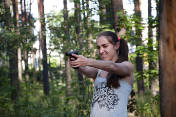 Girl shooting from gun.