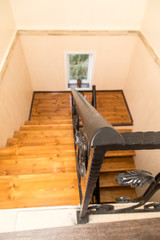 wooden staircase with metal railing in the house
