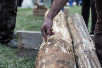 woodcutter village feast, a competitor indicates the point where to cut the trunk