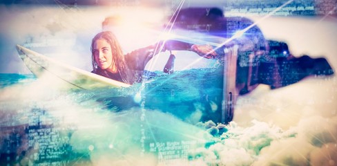 Composite image of woman in wetsuit with a surfboard on a sunny
