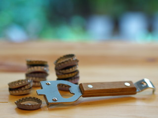 Bottle Opener with a cap on a wooden table. Natural Light.