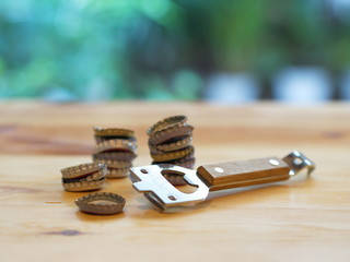 Bottle Opener with a cap on a wooden table. Natural Light.