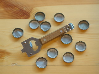 Bottle Opener with a cap on a wooden table. Natural Light.