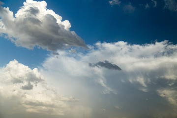rain clouds on a blue sky as a background
