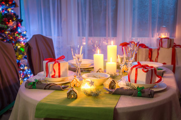 Gorgeous Christmas table setting with candles and gingerbread
