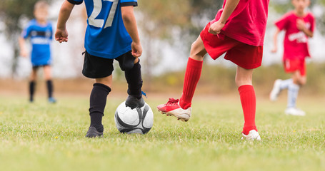 Obraz premium Kids soccer football - children players match on soccer field