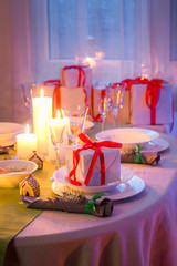 Beautiful Christmas table setting with candles and gingerbread