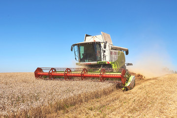 Fototapeta na wymiar A modern combine harvester working a wheat field