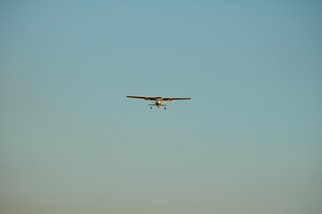small white single engine passenger plane just before landing