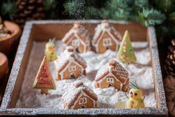 Cute Christmas gingerbread village with snowman and trees