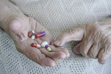 pills on palm of a senior woman