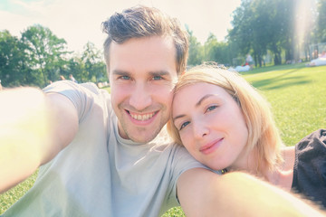 Fototapeta premium Young couple smiling while taking selfie