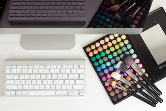 Makeup palette with brushes, keyboard and monitor