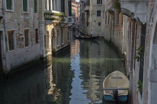 Traditional gondola ride in small canal at residential district of historical buildings and bridge, Venezia, Venice, Italy, Europe