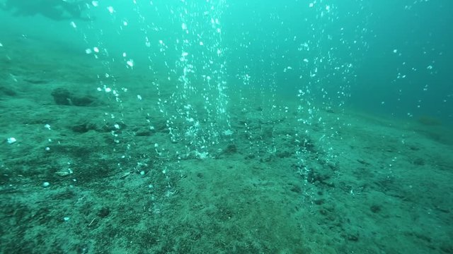 Hot water bubbles, rising from underwater volcano on ocean floor at Pulau Weh, Indonesia 