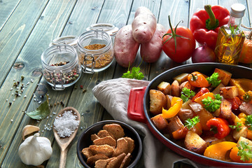 Rustic, oven baked vegetables with spices and herbs in baking dish