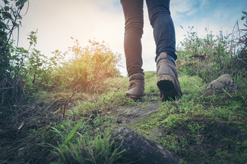 Woman walking on hiking trail in forest Active woman backpacker traveling on the nature.