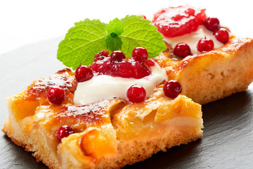Apple cake with cream, jam and forest berries