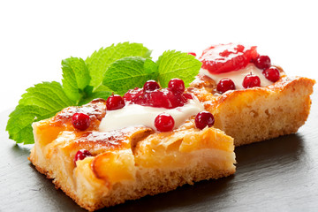 Apple cake with cream, jam and forest berries