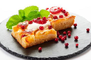 Apple cake with cream, jam and forest berries