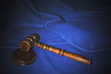 The judge's gavel on a dark blue background