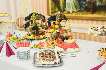 Delicious sweets on wedding candy buffet with desserts, cupcakes
