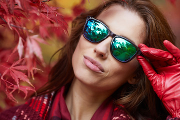 Portrait of beautiful brunette girl walking the park. Smiling. Warm sunny weather. Outdoors