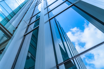 Fototapeta na wymiar Clouds Reflected in Windows of Modern Office Building..