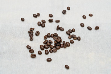 Coffee beans on sackcloth texture background.