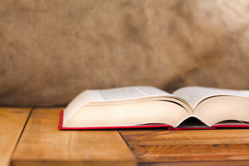 Composition with vintage old hardback books on wooden desk table. Education background.