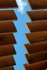 the sun canopy, the wooden slats on the sky background, part of the roof