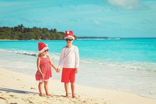 kids celebrating christmas on tropical beach
