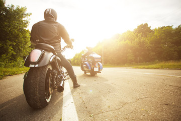 two bikers riding unknown motorbike with blur movement, speed concept