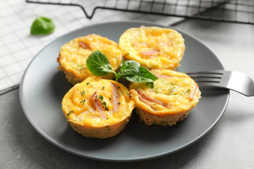 Plate with tasty egg muffins on table