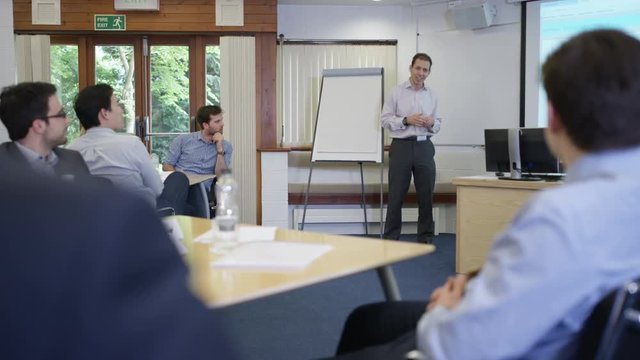  Real business group listening to the speaker at a business seminar