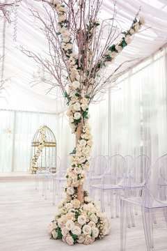 Tree decorated with beautiful flowers in wedding hall