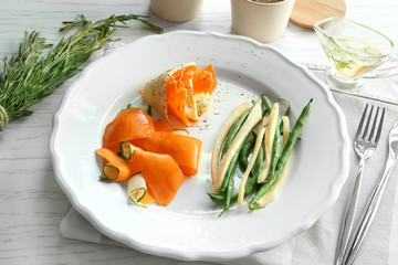 Carrot salad with cucumber and green beans on kitchen table