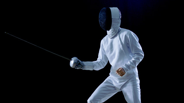 One Professional Fencer is Standing Ready for Fighting. Shot Isolated on Black Background with Cold Tones.