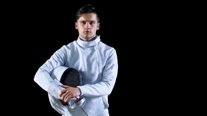 Portrait Shot of a Young Fencer Standing and Looking into Camera. Shot Isolated on Black Background.