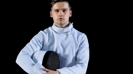 Portrait Shot of a Young Fencer Standing and Looking into Camera. Shot Isolated on Black Background.