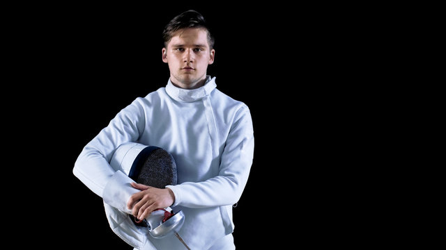 Portrait Shot of a Young Fencer Standing and Looking into Camera. Shot Isolated on Black Background.